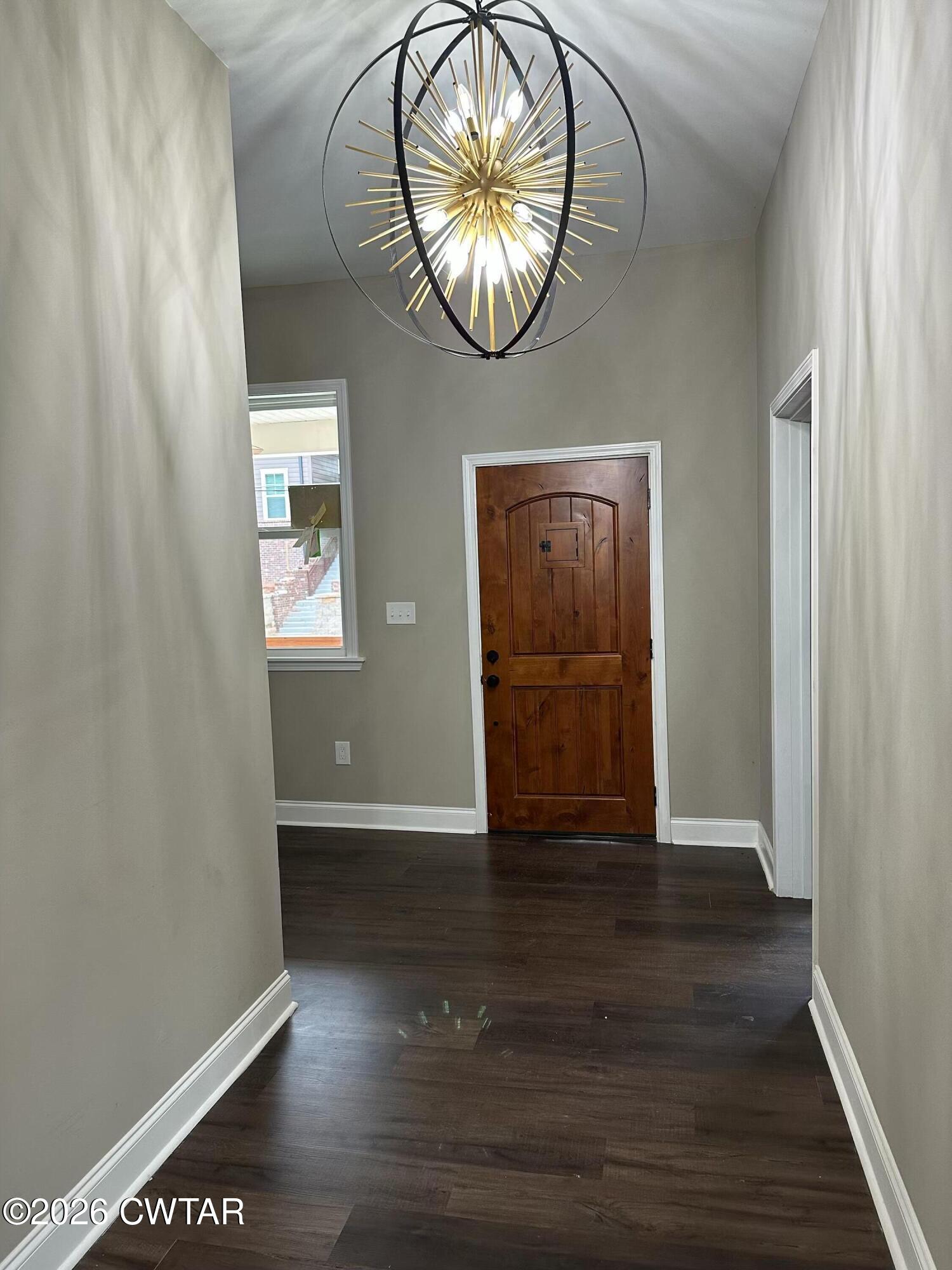237 Talbot Street Jackson, TN 38301 - Photo 6 of 38 an empty room with wooden floor mirror and windows