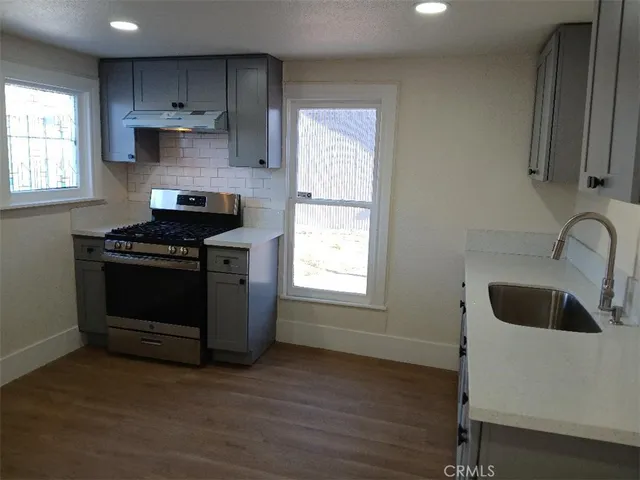 a kitchen with a stove and a sink