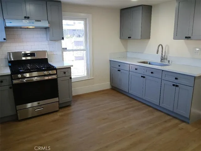 a kitchen with wooden cabinets and a stove top oven