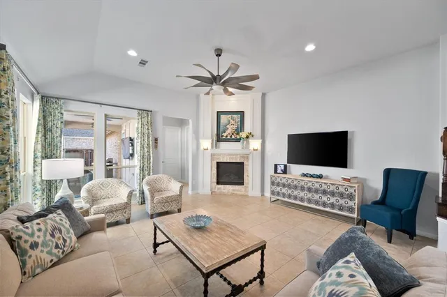 a living room with furniture a fireplace and a flat screen tv