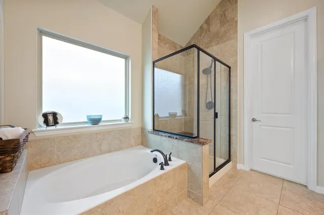 a bathroom with a bathtub and a shower