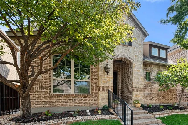 front view of a house with a tree