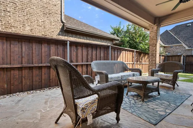 a backyard of a house with table and chairs