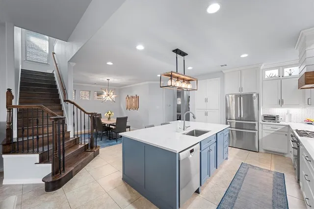 a kitchen with stainless steel appliances kitchen island a large counter top and stove