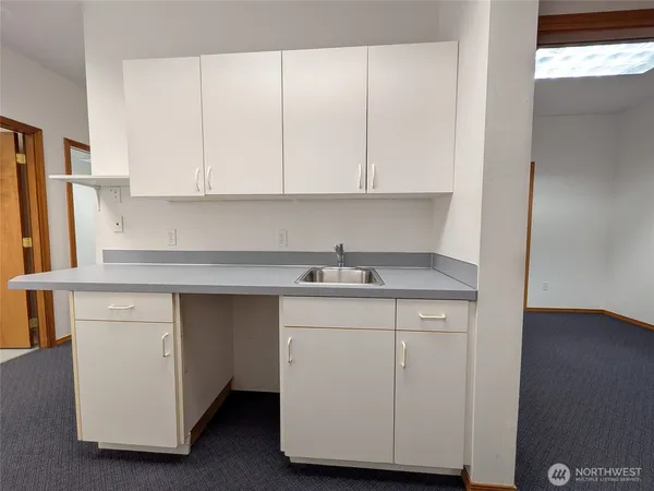 a kitchen with a sink cabinets and a window