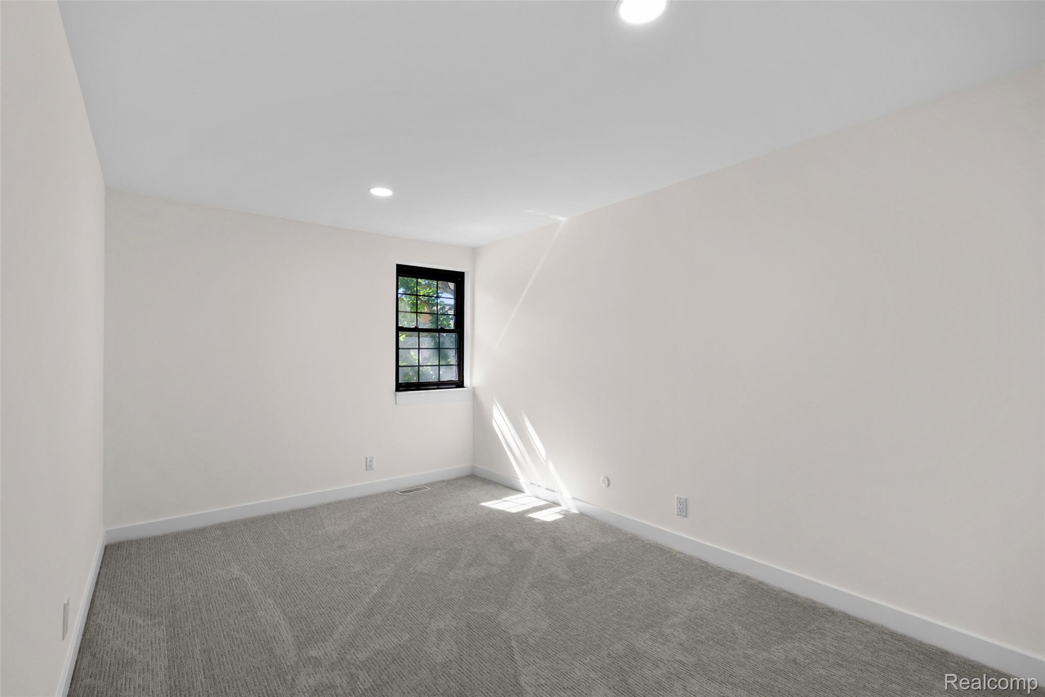 1830 Streamedge Court Rochester, MI 48309 - Photo 15 of 33 Recessed lighting, wall-to-wall carpeting, and a window with dark framing