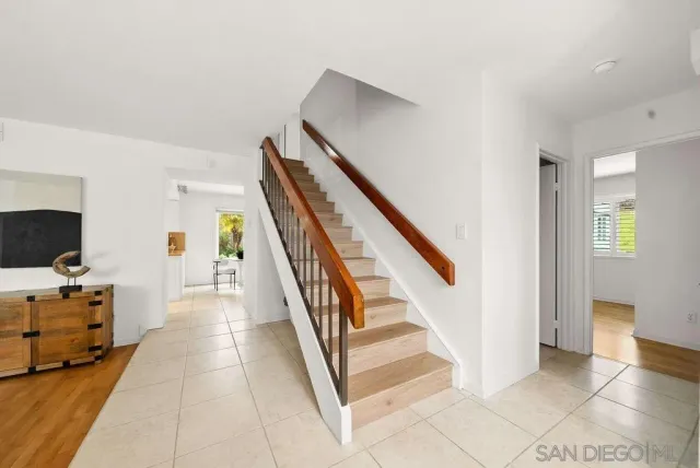 a view of a hallway with workspace and stairs