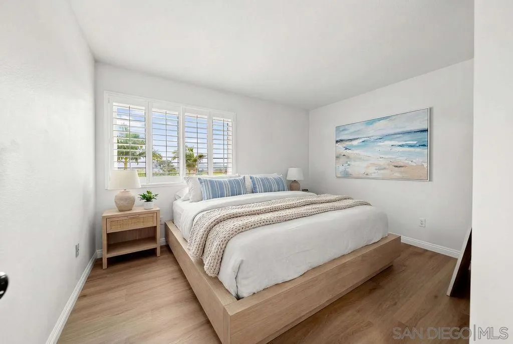 2210 Valley Road Oceanside, CA 92056 - Photo 19 of 45 a bedroom with a bed and wooden floor