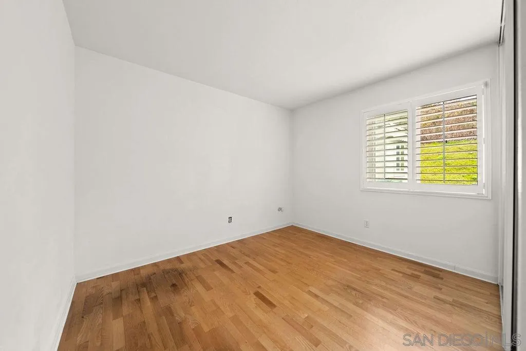 2210 Valley Road Oceanside, CA 92056 - Photo 23 of 45 a view of an empty room with wooden floor and a window