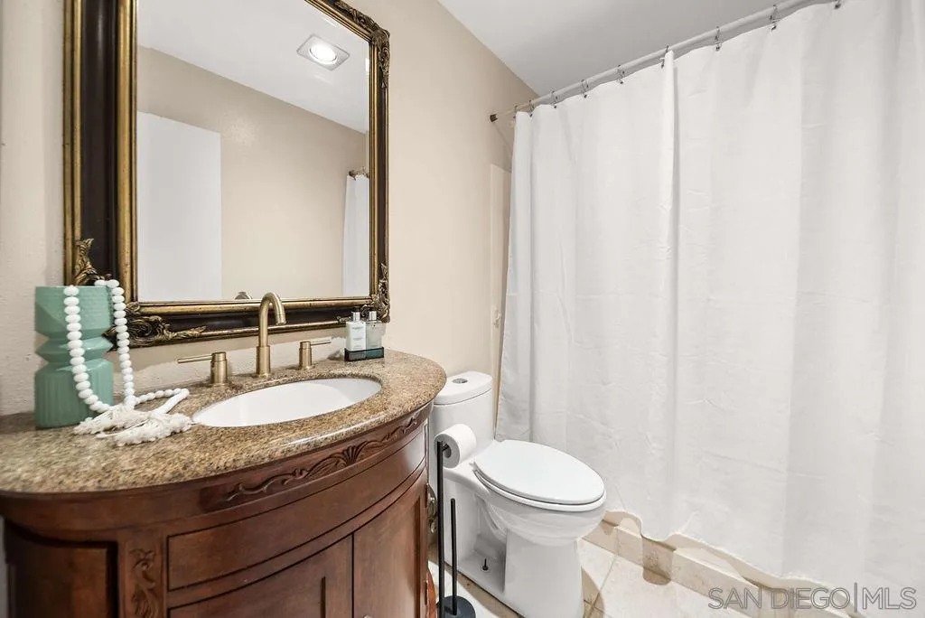 2210 Valley Road Oceanside, CA 92056 - Photo 25 of 45 a bathroom with a granite countertop sink and a mirror