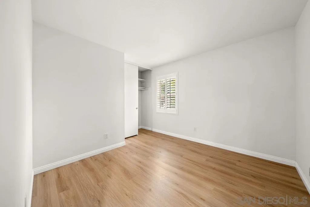 2210 Valley Road Oceanside, CA 92056 - Photo 27 of 45 an empty room with wooden floor and windows