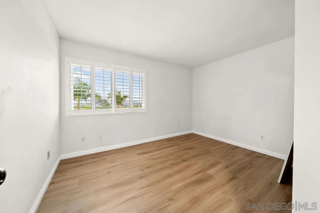 2210 Valley Road Oceanside, CA 92056 - Photo 28 of 45 an empty room with wooden floor and windows