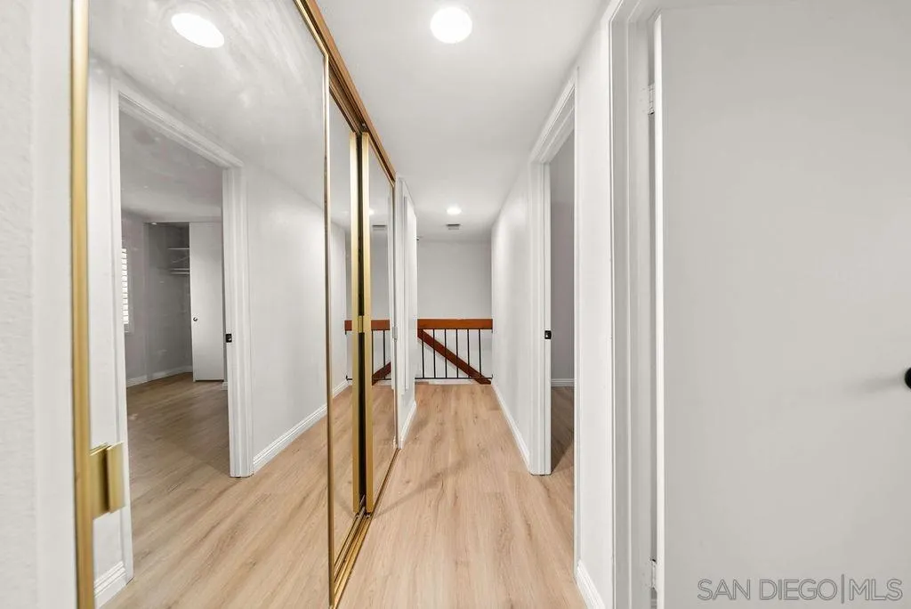 2210 Valley Road Oceanside, CA 92056 - Photo 30 of 45 a view of a hallway with wooden floor and staircase