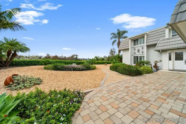 a picture of a houses with a yard and plants