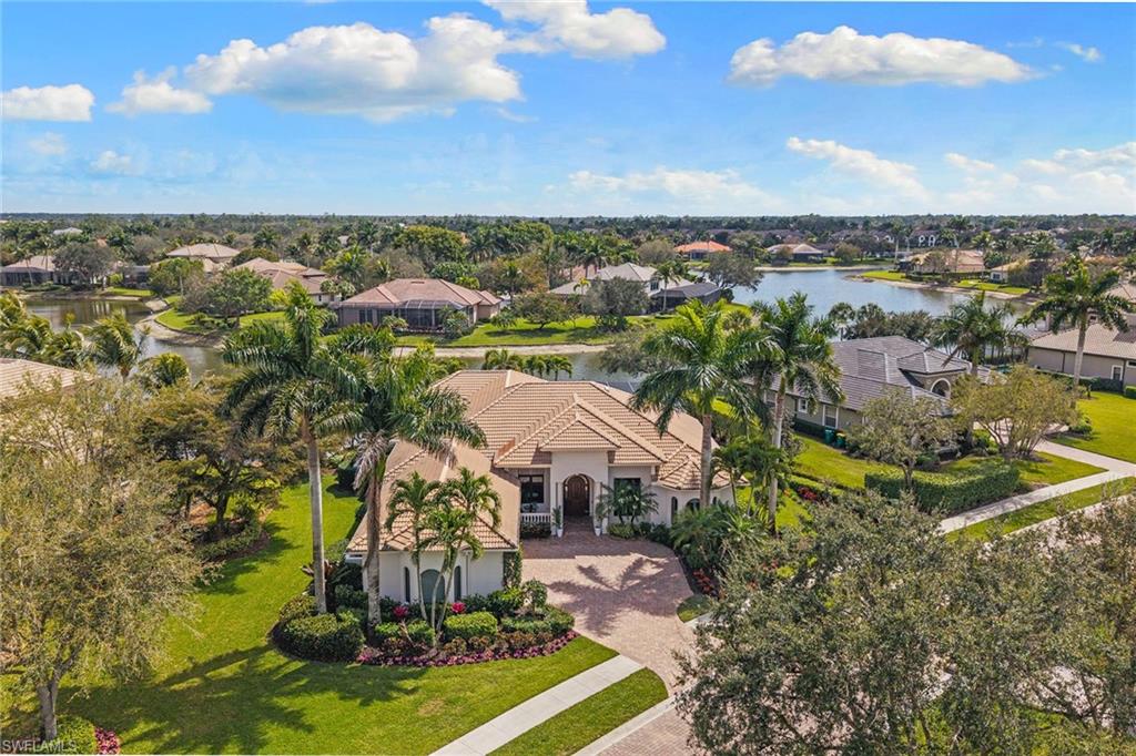 7506 Hogan Court Naples, FL 34113 - Photo 1 of 49 Aerial perspective of suburban area featuring a nearby body of water
