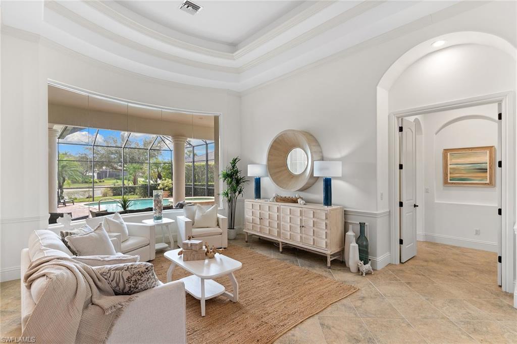 7506 Hogan Court Naples, FL 34113 - Photo 15 of 49 Bedroom with a sunroom, a raised ceiling, ornamental molding, and light stone finish flooring