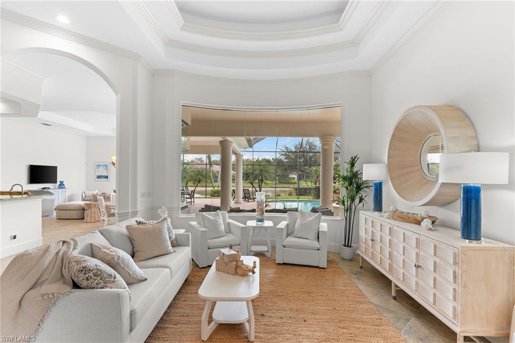 7506 Hogan Court Naples, FL 34113 - Photo 17 of 49 Living room with a high tray ceiling and crown molding