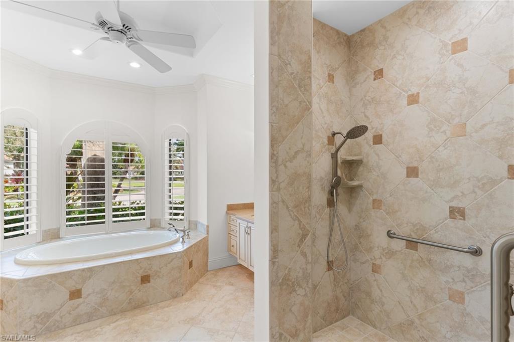 7506 Hogan Court Naples, FL 34113 - Photo 20 of 49 Full bath with walk in shower, a garden tub, vanity, ornamental molding, and ceiling fan