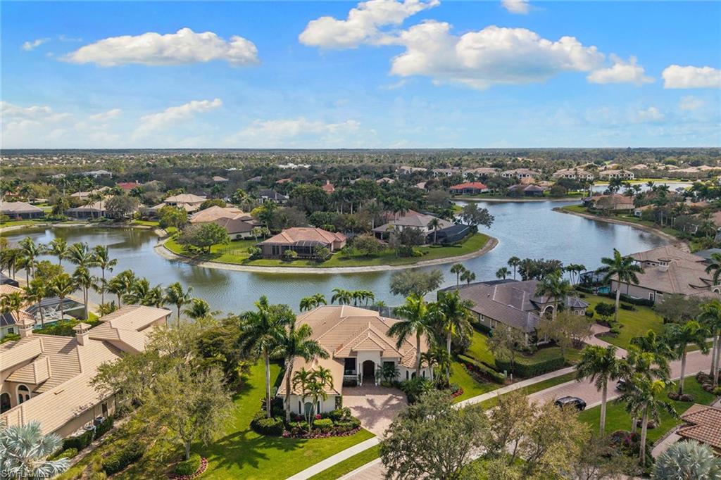 7506 Hogan Court Naples, FL 34113 - Photo 2 of 49 Aerial perspective of suburban area with a large body of water