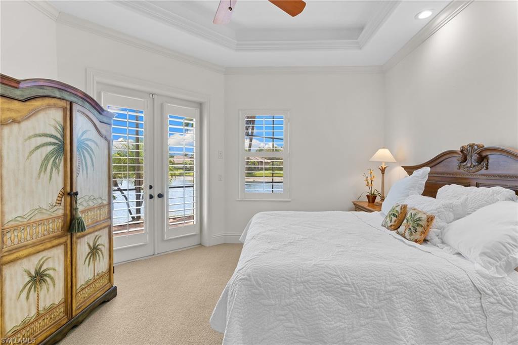 7506 Hogan Court Naples, FL 34113 - Photo 22 of 49 Bedroom with access to outside, a ceiling fan, light carpet, ornamental molding, and french doors