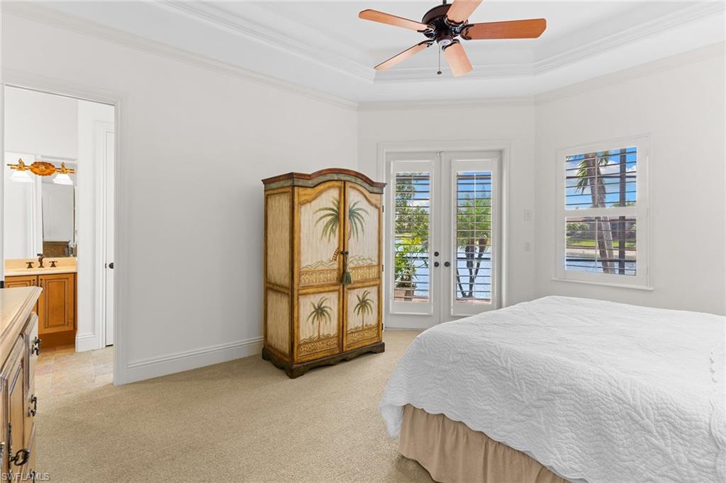 7506 Hogan Court Naples, FL 34113 - Photo 24 of 49 Bedroom featuring access to outside, a ceiling fan, light colored carpet, french doors, and crown molding
