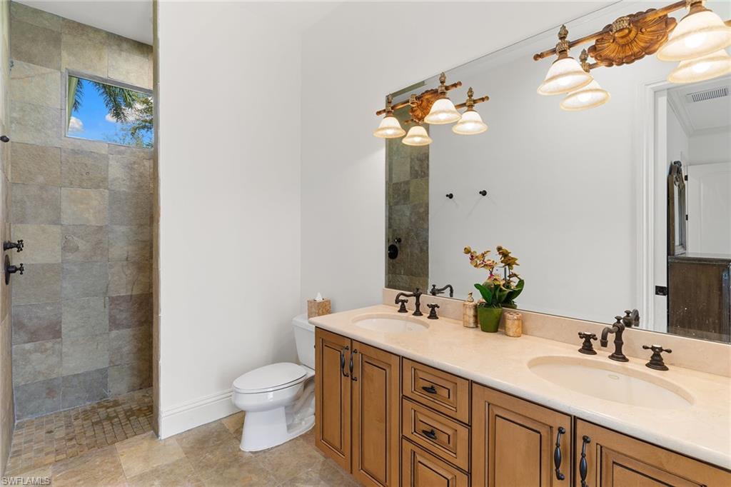 7506 Hogan Court Naples, FL 34113 - Photo 25 of 49 Full bathroom with double vanity and walk in shower