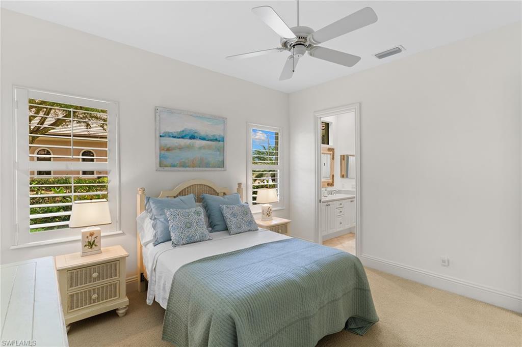 7506 Hogan Court Naples, FL 34113 - Photo 27 of 49 Bedroom featuring light colored carpet, ensuite bathroom, and ceiling fan