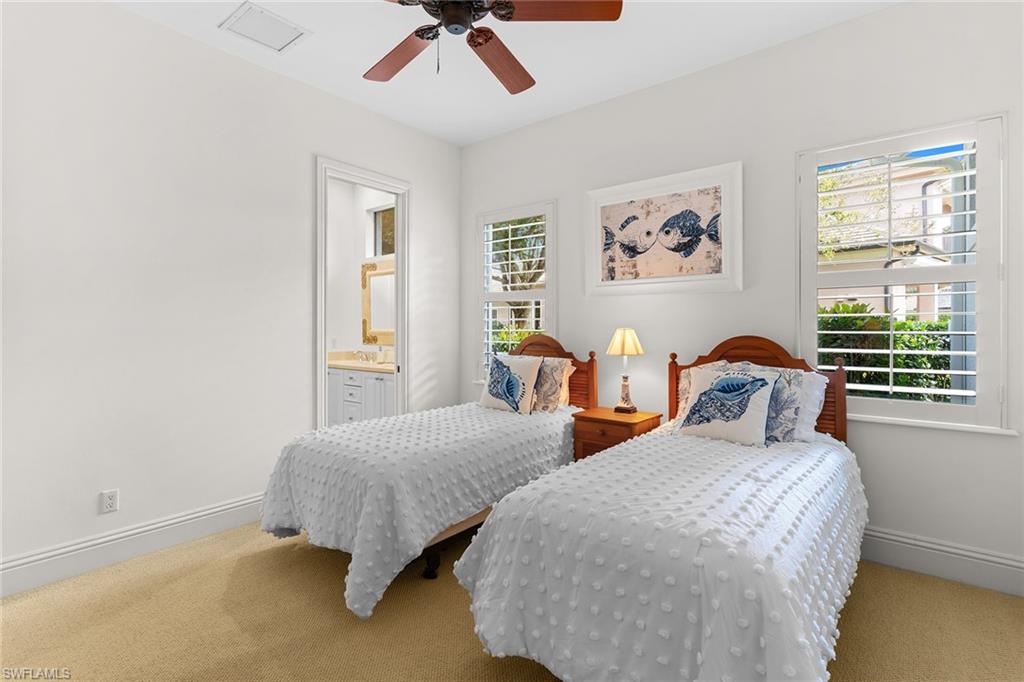 7506 Hogan Court Naples, FL 34113 - Photo 29 of 49 Carpeted bedroom featuring multiple windows and a ceiling fan