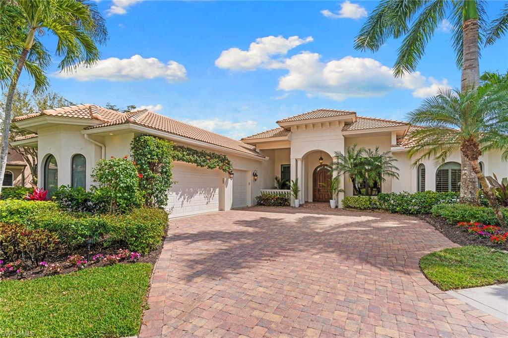 7506 Hogan Court Naples, FL 34113 - Photo 3 of 49 Mediterranean / spanish house with stucco siding, decorative driveway, a garage, and a tile roof