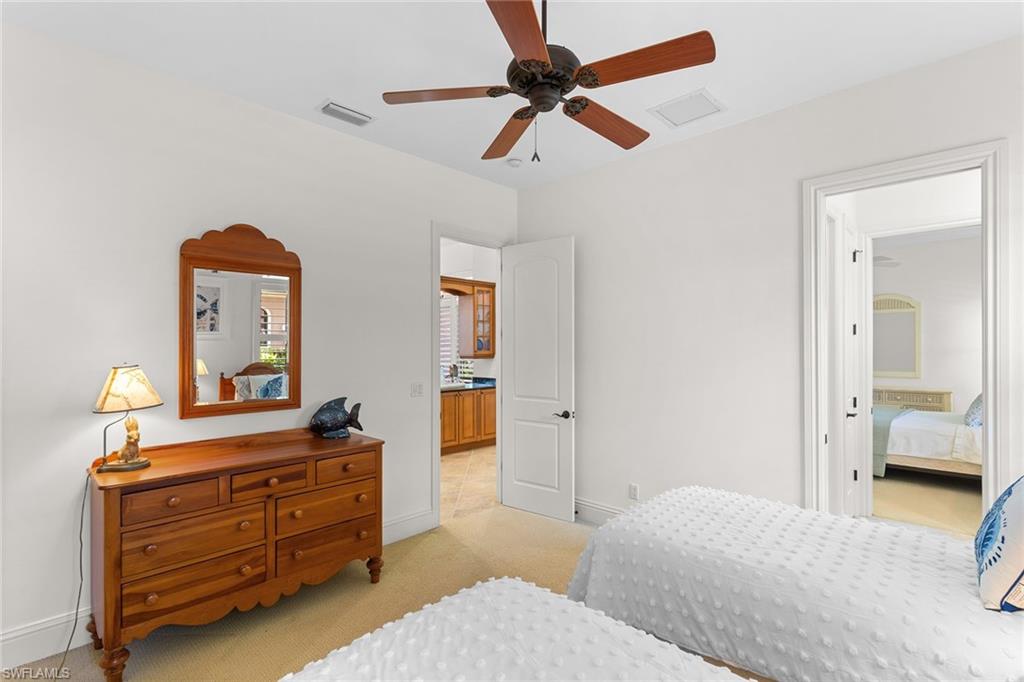 7506 Hogan Court Naples, FL 34113 - Photo 31 of 49 Bedroom with light carpet and a ceiling fan