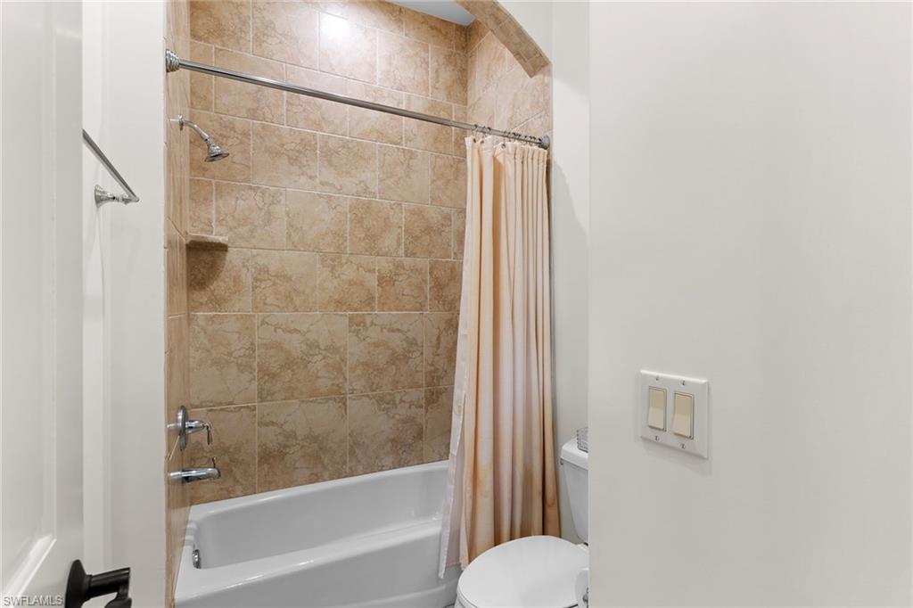 7506 Hogan Court Naples, FL 34113 - Photo 33 of 49 Full bathroom featuring toilet and shower / tub combo with curtain