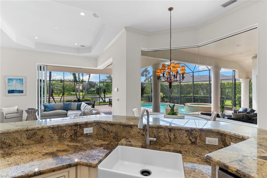 7506 Hogan Court Naples, FL 34113 - Photo 49 of 49 Kitchen with open floor plan, a sunroom, and crown molding