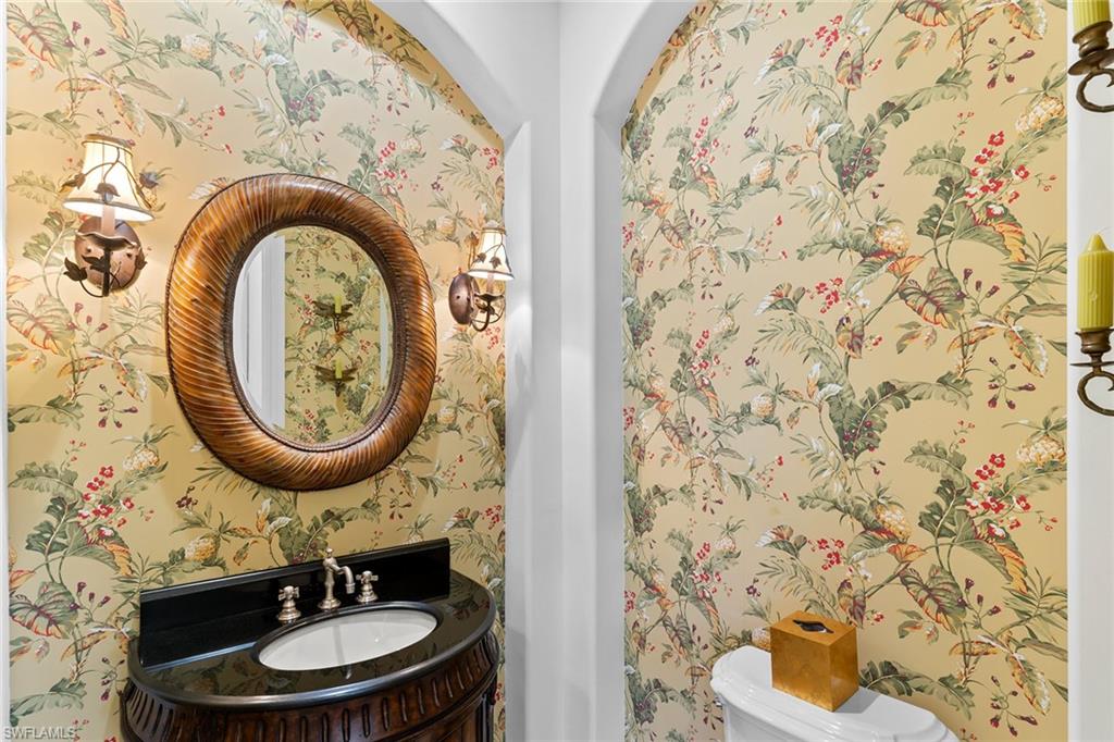 7506 Hogan Court Naples, FL 34113 - Photo 38 of 49 Half bath featuring vanity and wallpapered walls