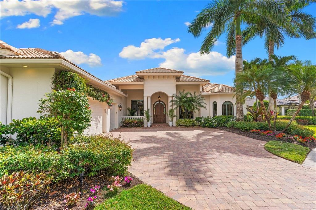 7506 Hogan Court Naples, FL 34113 - Photo 4 of 49 Mediterranean / spanish house featuring a garage, a tile roof, decorative driveway, and stucco siding