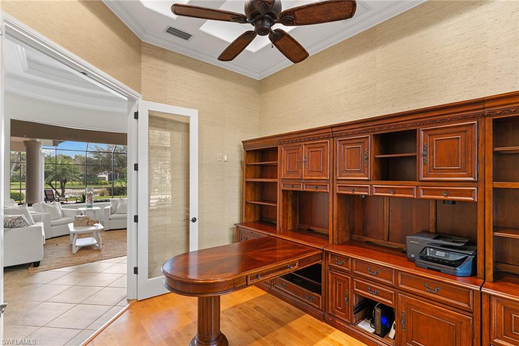 7506 Hogan Court Naples, FL 34113 - Photo 39 of 49 Office with light wood finished floors, ornamental molding, a ceiling fan, wallpapered walls, and a high ceiling