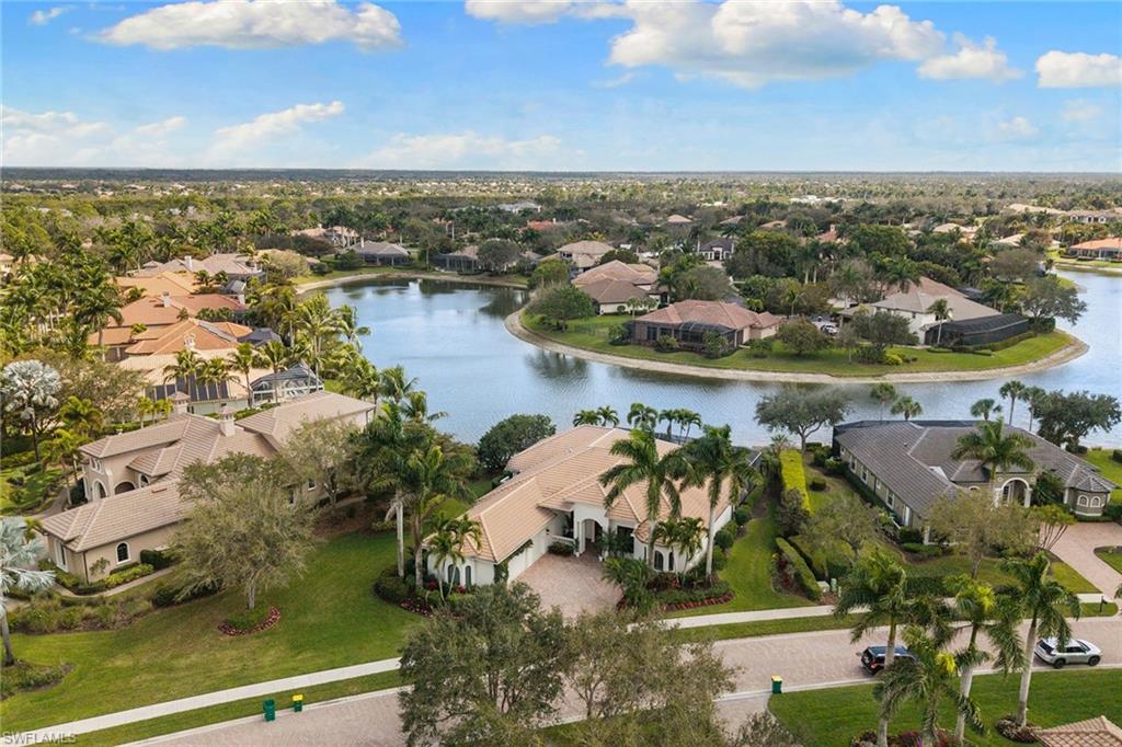 7506 Hogan Court Naples, FL 34113 - Photo 43 of 49 Aerial view of residential area with a nearby body of water