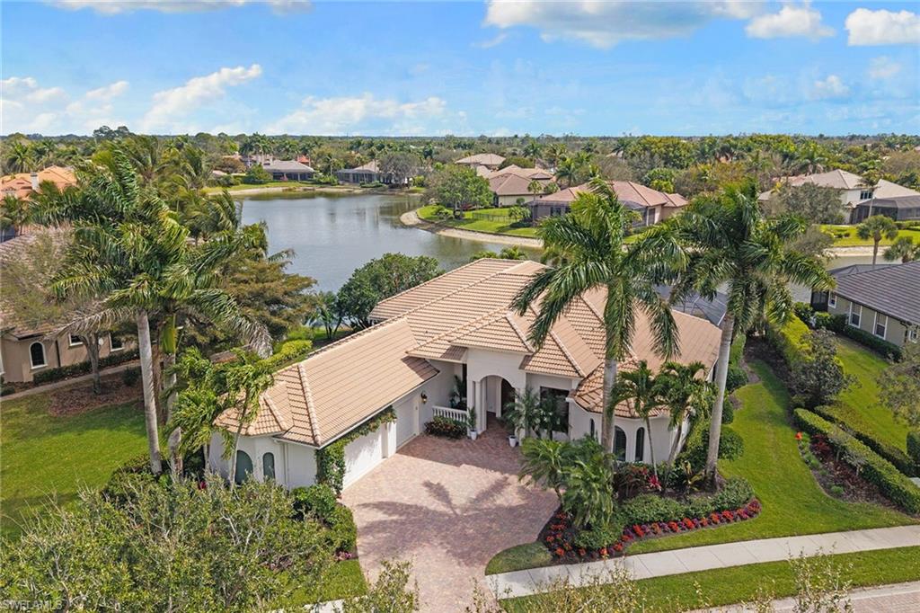 7506 Hogan Court Naples, FL 34113 - Photo 44 of 49 Aerial view of residential area featuring a large body of water