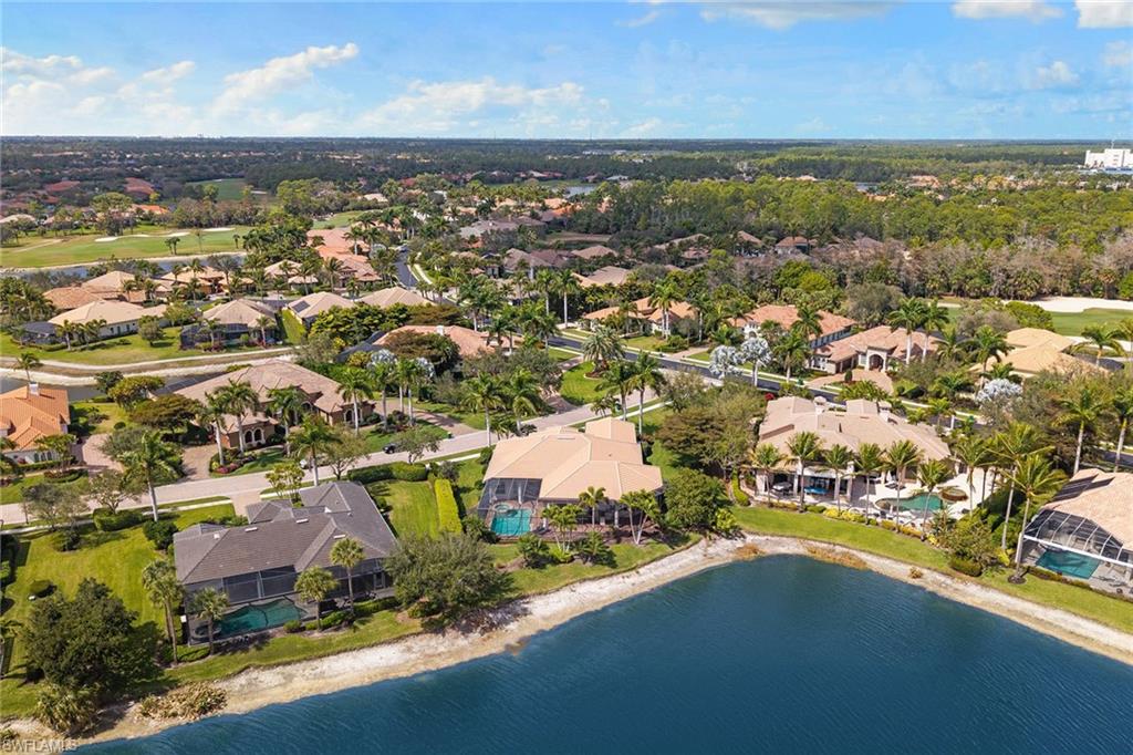 7506 Hogan Court Naples, FL 34113 - Photo 45 of 49 Aerial view of residential area with a nearby body of water