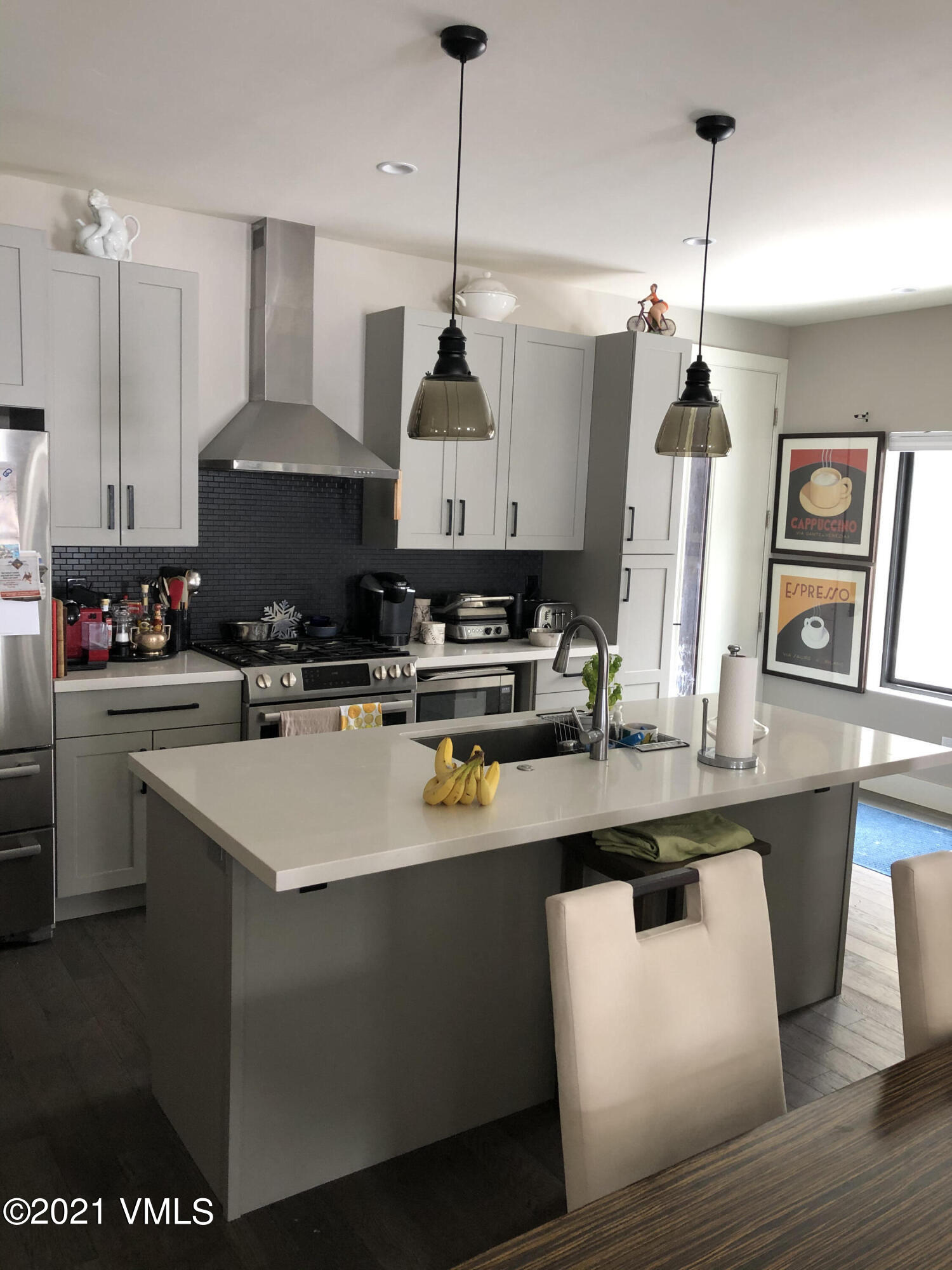 1133 Main Street Minturn, CO 81645 - Photo 3 of 13 a kitchen with stainless steel appliances granite countertop a sink a stove a refrigerator a center island and cabinets