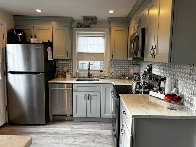 a kitchen with refrigerator and cabinets