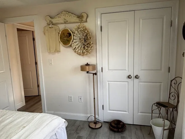 a bedroom with a bed and a mirror