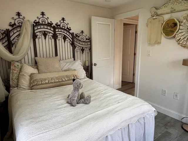 a bedroom with a bed and a chandelier