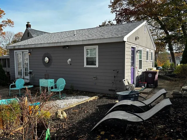 a view of backyard of house with outdoor seating