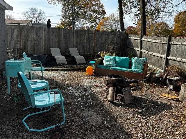 a backyard of a house with outdoor seating