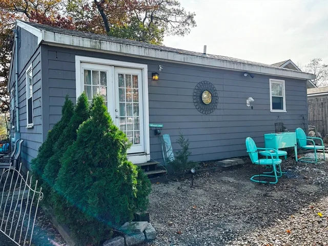 a front view of a house with yard and chairs