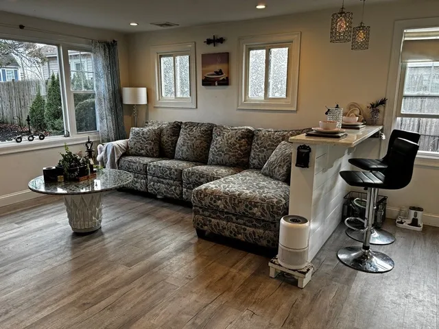 a living room with furniture window and wooden floor