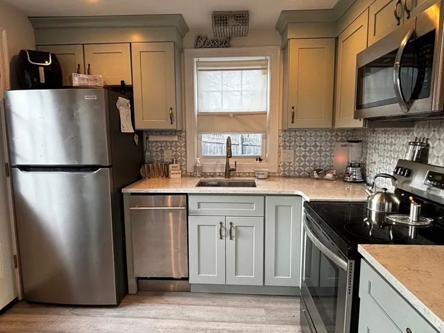 a kitchen with a refrigerator stove and sink