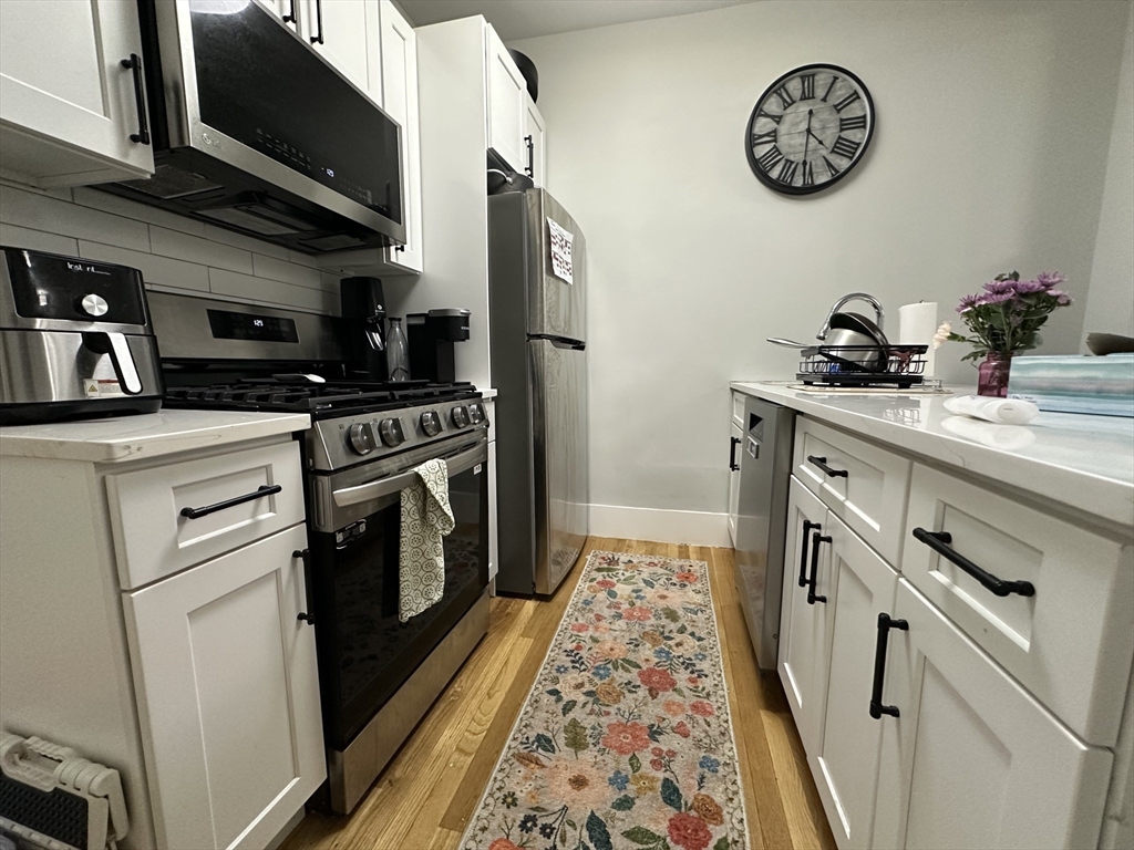 68 L Street, Unit 1 Boston, MA 02127 - Photo 1 of 12 a kitchen with a sink stove and cabinets