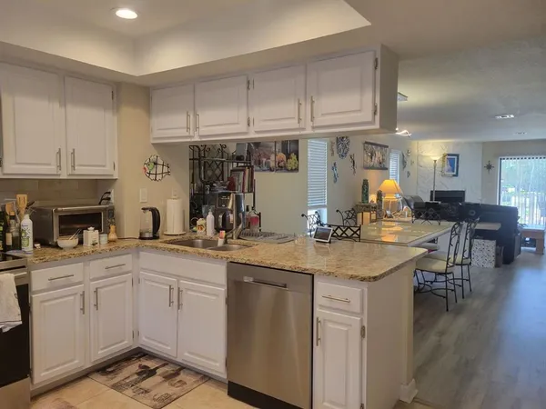 a view of kitchen with furniture and wooden cabinets