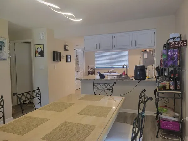 a kitchen with kitchen island granite countertop a sink cabinets and stainless steel appliances